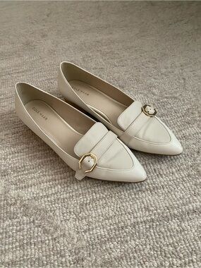 Cole Haan Cream Pointed Toe Loafers with Gold Buckle Accent